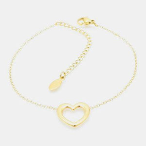 a gold heart bracelet on a white background