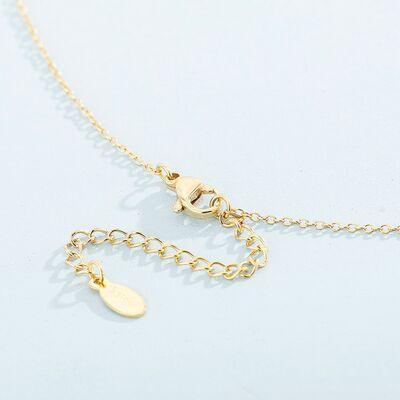 a gold necklace with two charms hanging from it