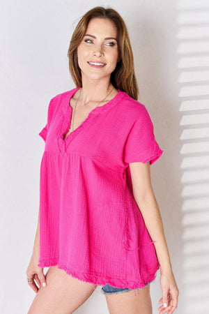 a woman in a pink top posing for a picture