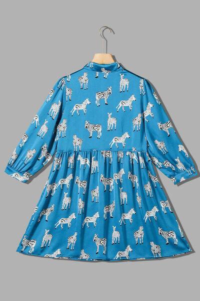 a blue dress with white zebras on it