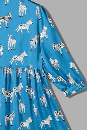 a blue dress with zebras and giraffes on it