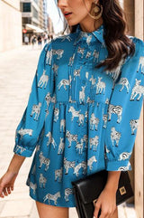 a woman in a blue dress with zebras on it