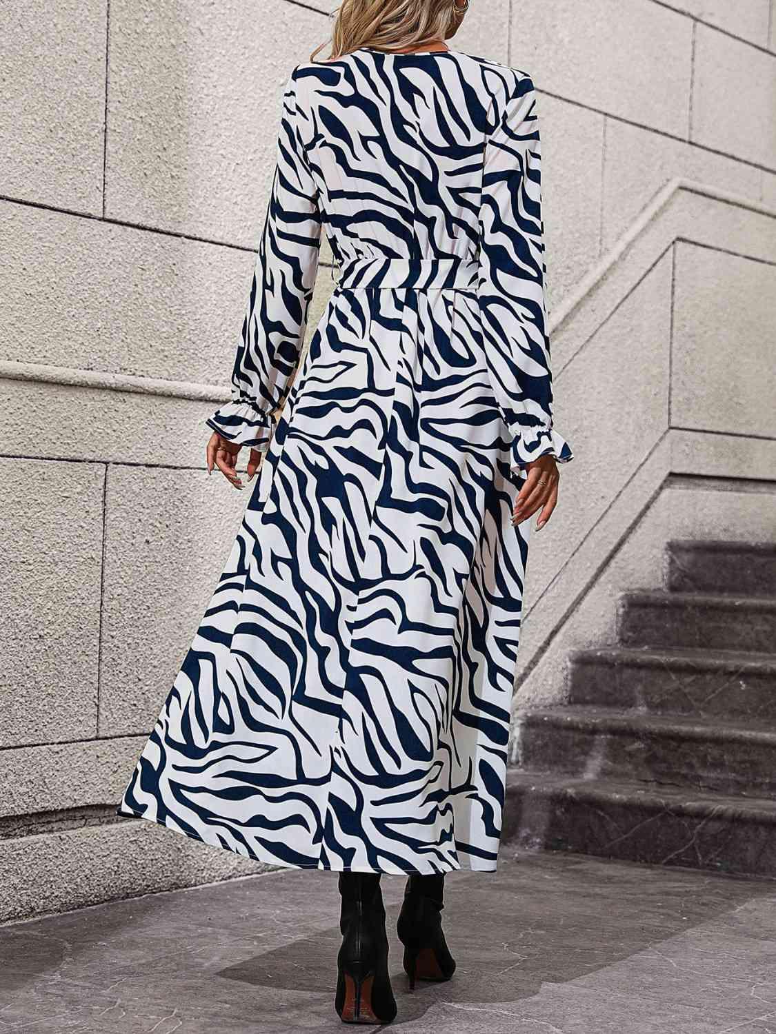 a woman wearing a zebra print dress