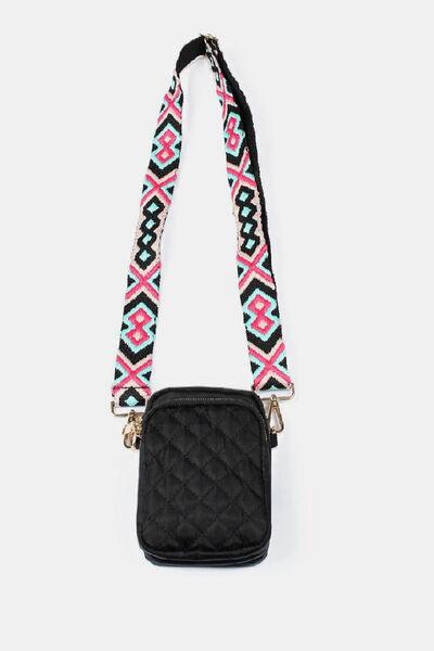 a black cross body bag with a pink and blue pattern