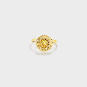 a gold ring with a sunflower on it