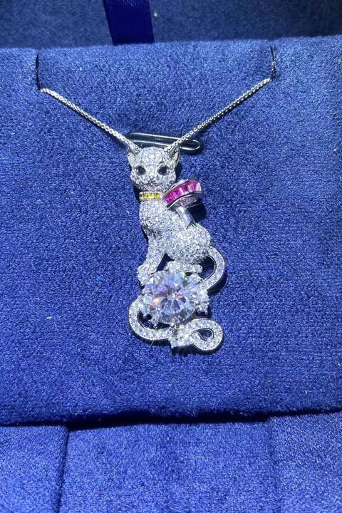 a necklace with a cat sitting on top of it