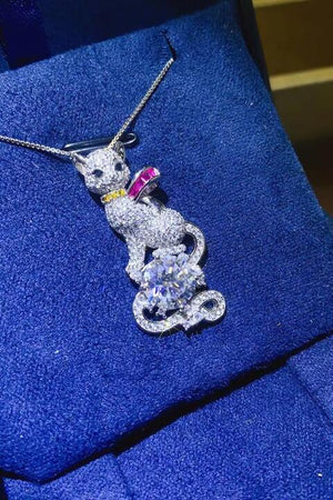 a necklace with a cat sitting on top of it