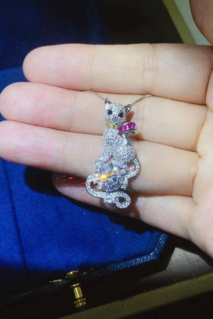 a person holding a cat shaped ring in their hand