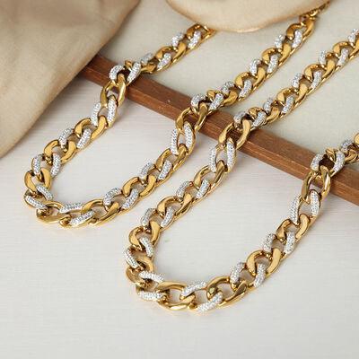 a close up of a gold chain on a table