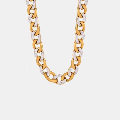 a gold and diamond necklace on a white background