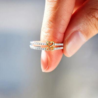 a person holding a ring with a heart on it