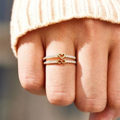 a close up of a person's hand with two rings