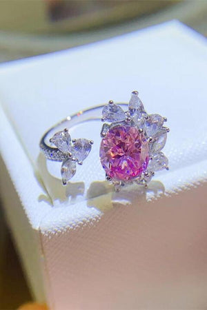 a pink diamond ring sitting on top of a white box