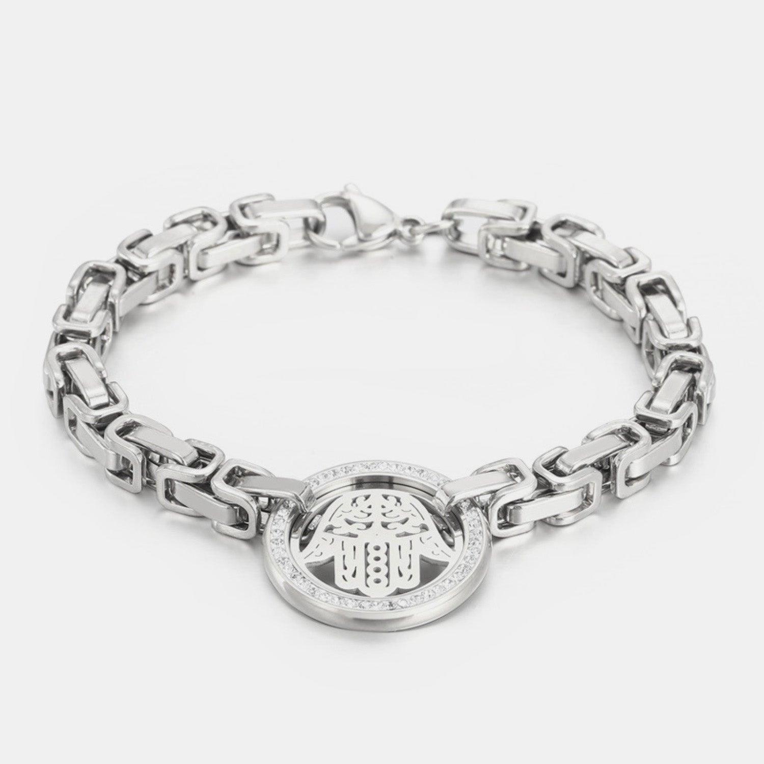 a silver bracelet with an emblem on it