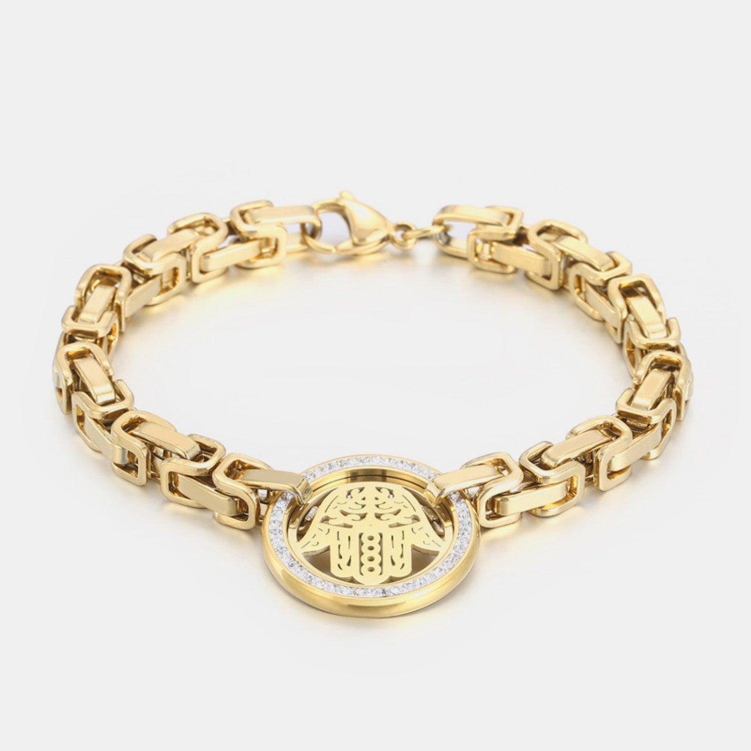 a gold bracelet with a hamsah charm