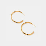 a pair of gold hoop earrings on a white background