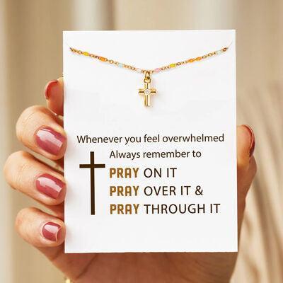 a woman holding a card with a cross on it