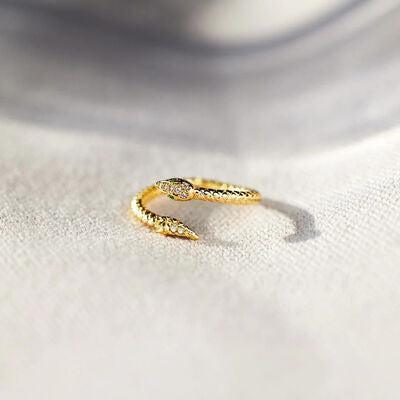 a close up of a gold ring on a white cloth