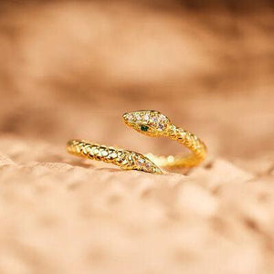 a pair of gold rings with green stones