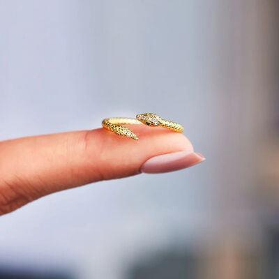 a woman's hand with a gold ring on it