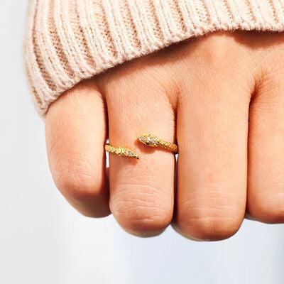 a woman's hand with two gold rings on it