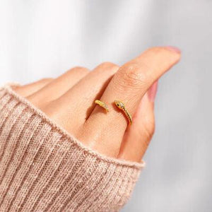 a woman's hand with a gold ring on it