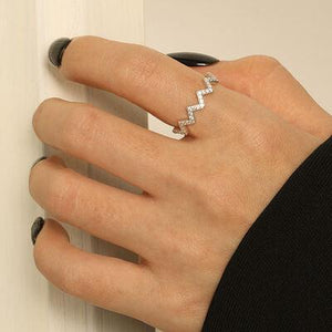 a woman's hand with a diamond ring on it