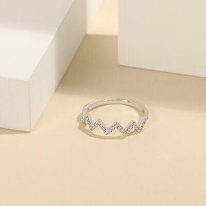 a diamond ring sitting on top of a table