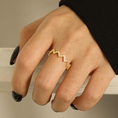 a woman's hand with a gold ring on it