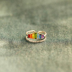 a rainbow colored ring sitting on top of a table