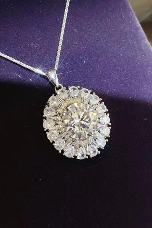 a diamond pendant on a purple velvet surface