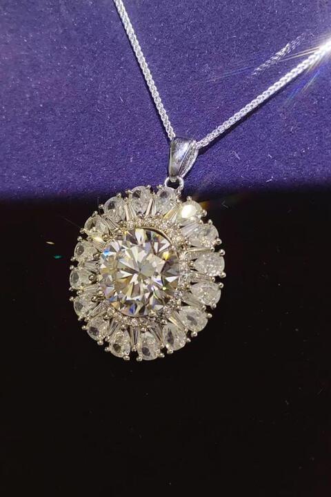 a diamond pendant on a purple surface