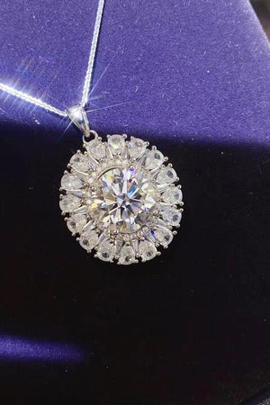 a diamond pendant on a purple velvet box