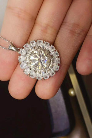 a person holding a diamond ring in their hand