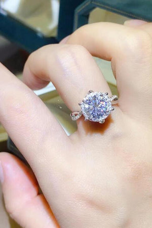 a close up of a person's hand holding a ring