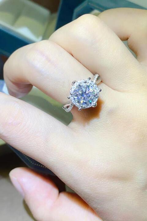 a close up of a person's hand holding a ring