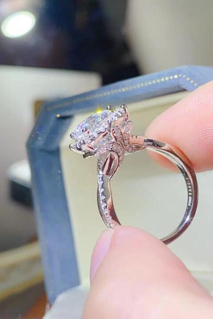 a close up of a person holding a ring