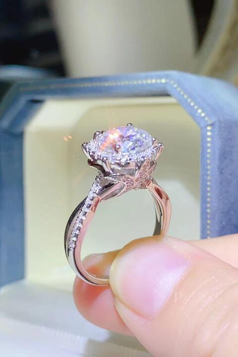 a close up of a person holding a ring