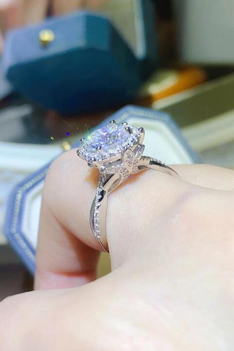 a close up of a person's hand holding a ring