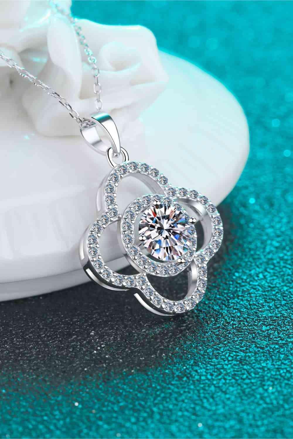a white diamond necklace on a blue surface