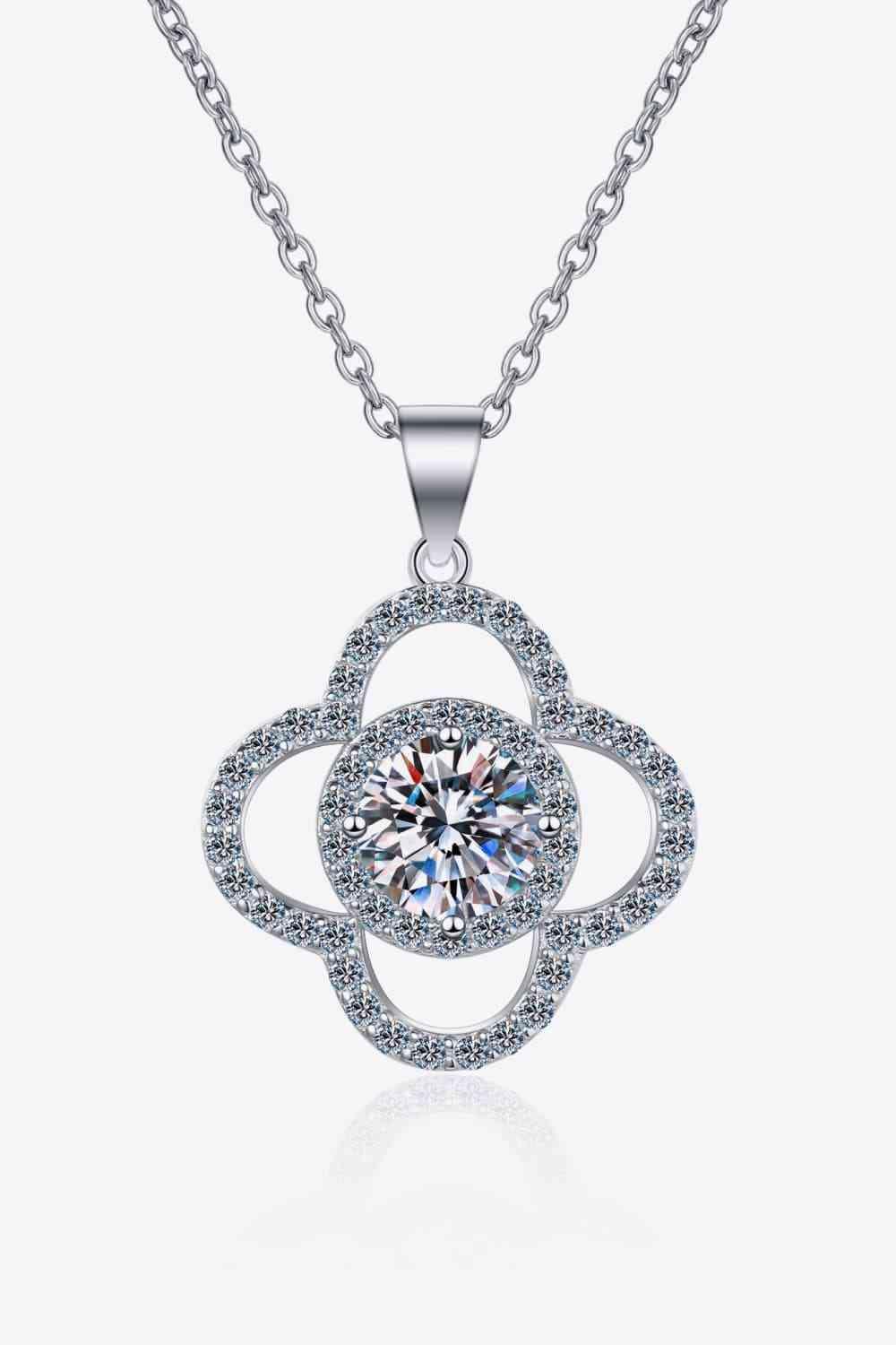 a white gold necklace with a flower design