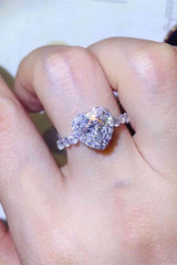 a close up of a person's hand holding a diamond ring