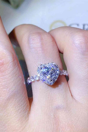 a close up of a person's hand with a ring on it