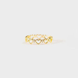 a gold ring with hearts on it