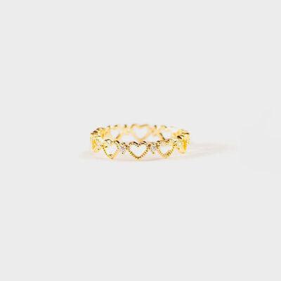 a gold ring with hearts on it