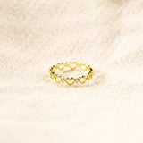 a gold ring on a white cloth