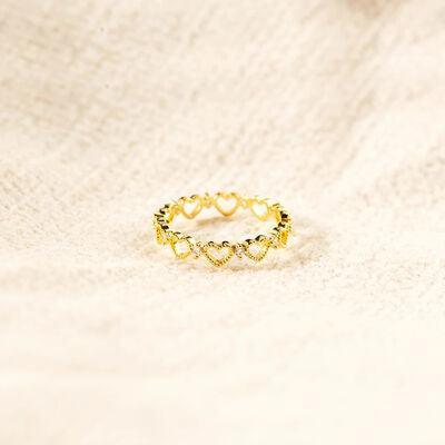 a gold ring on a white cloth