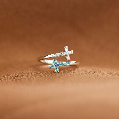 a ring with a cross on it sitting on a table