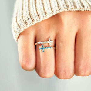 a person wearing a ring with a cross on it