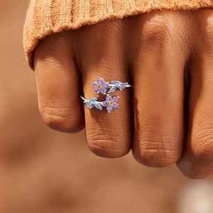 a close up of a person's hand with a ring on it